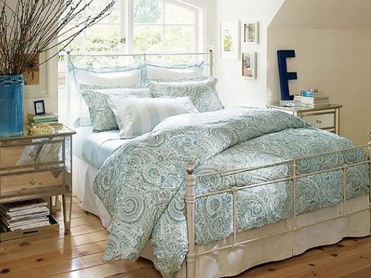 charming retro pattern bedding set with white wrought iron bed design in vintage bedroom idea plus hardwood flooring and mirrored cabinets